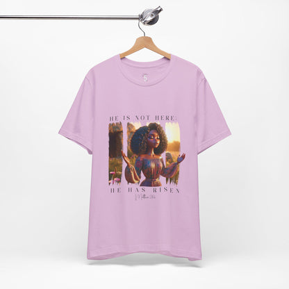 Lavender t-shirt with a 'He is Not Here' design on a hanger against a white background
