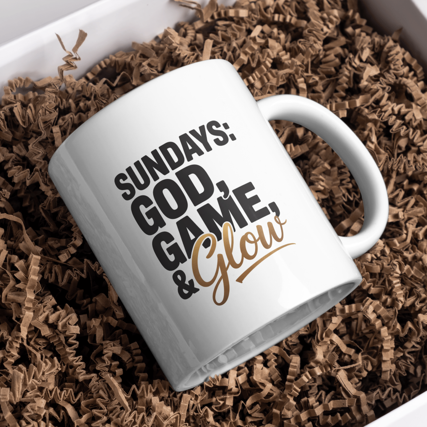 White mug with text 'Sundays: God, Game, & Glow' on brown crinkled paper