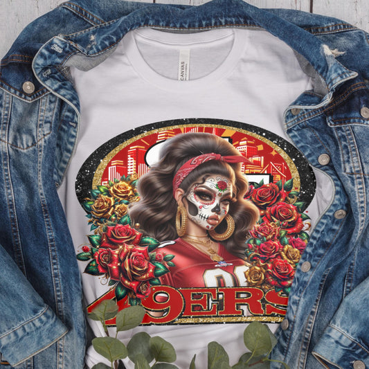 T-shirt with a design of a woman with a skull makeup and roses, wearing a sports jersey, under a denim jacket.
