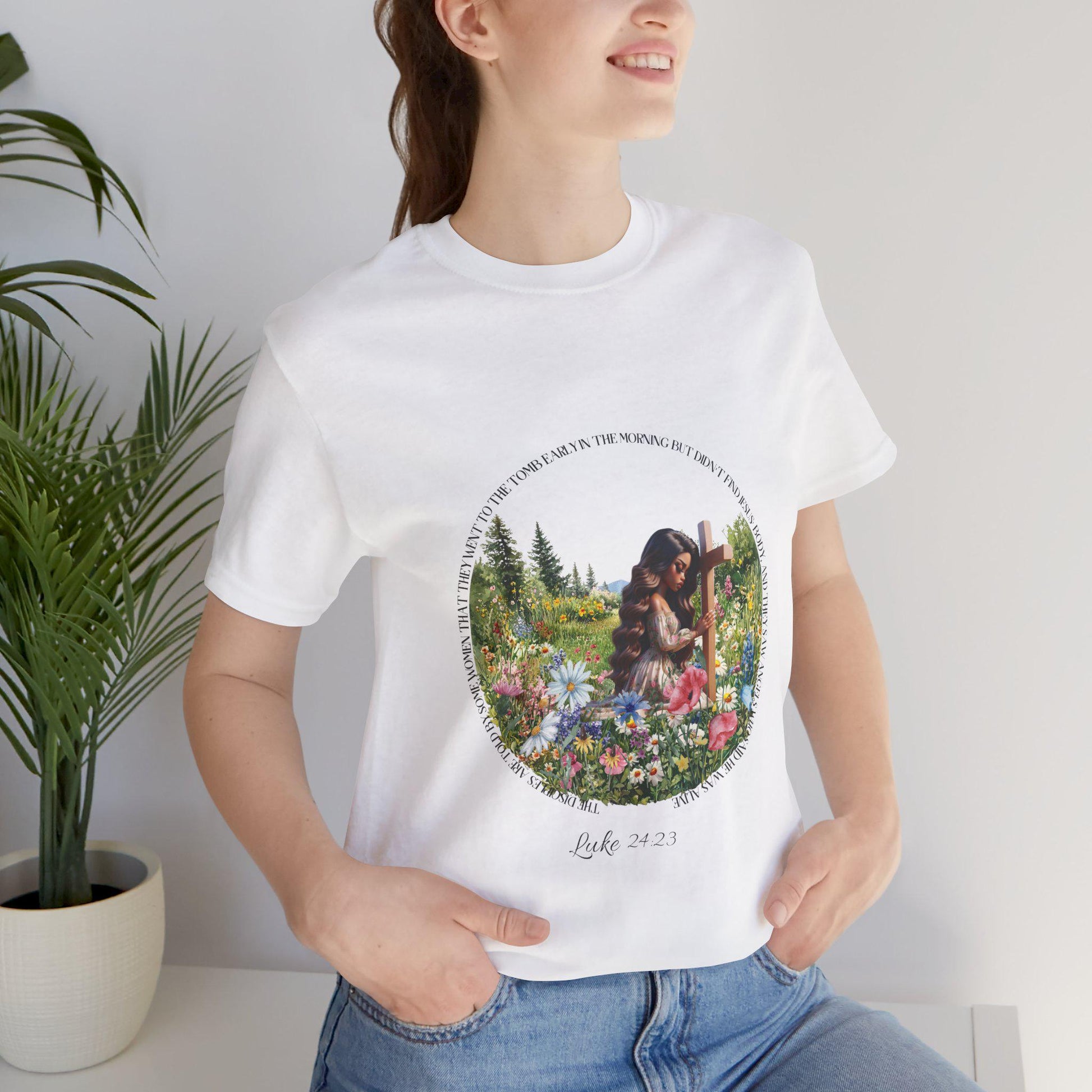 Person wearing a white t-shirt with a woman at a cross floral design 